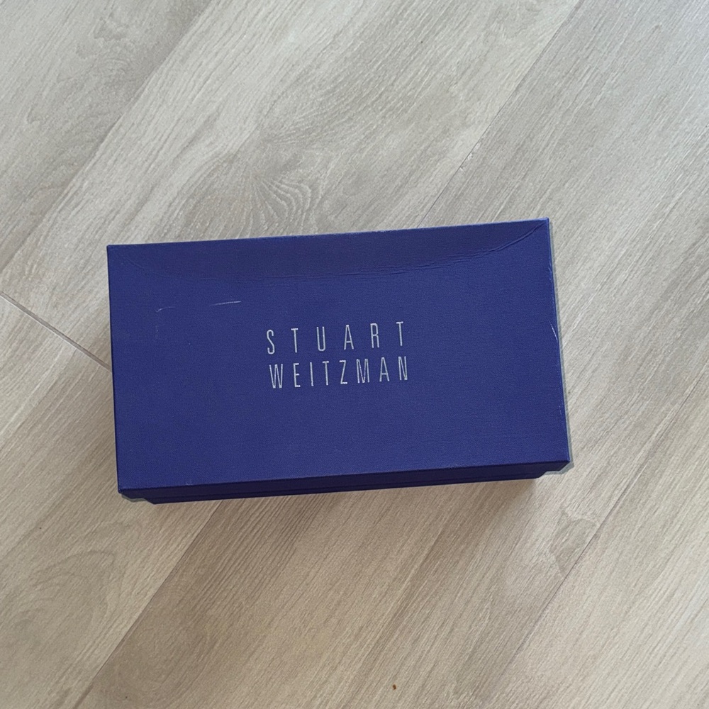 Stuart Weitzman black shoe with rhinestone detail.